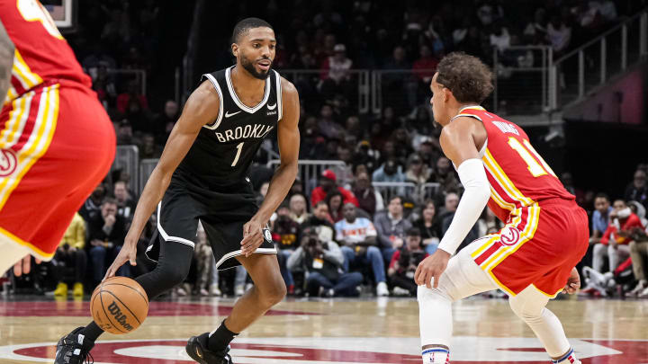 Dec 6, 2023; Atlanta, Georgia, USA; Brooklyn Nets forward Mikal Bridges (1) dribbles against Atlanta Hawks guard Trae Young (11) during the second half at State Farm Arena. Mandatory Credit: Dale Zanine-USA TODAY Sports