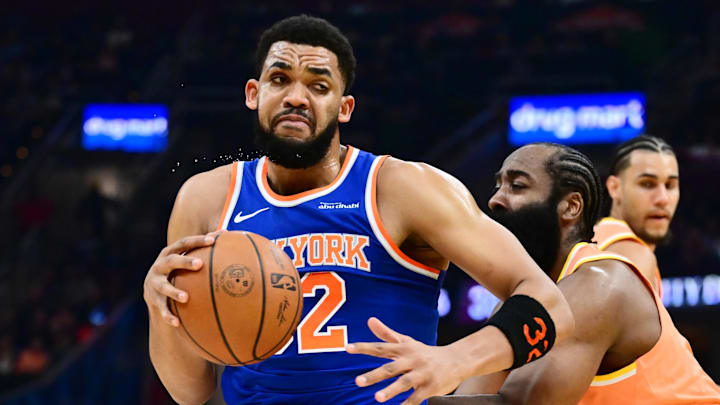 Feb 24, 2026; Cleveland, Ohio, USA; New York Knicks center Karl-Anthony Towns (32) drives to the basket against Cleveland Cavaliers guard James Harden (1) during the first half at Rocket Arena. Mandatory Credit: Ken Blaze-Imagn Images