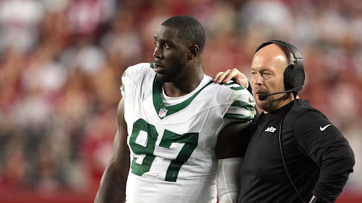 Sep 9, 2024; Santa Clara, California, USA; New York Jets defensive line coach Aaron Whitecotton (center right) talks with defensive end Jalyn Holmes (97) during the fourth quarter against the San Francisco 49ers at Levi's Stadium. Mandatory Credit: Darren Yamashita-Imagn Images