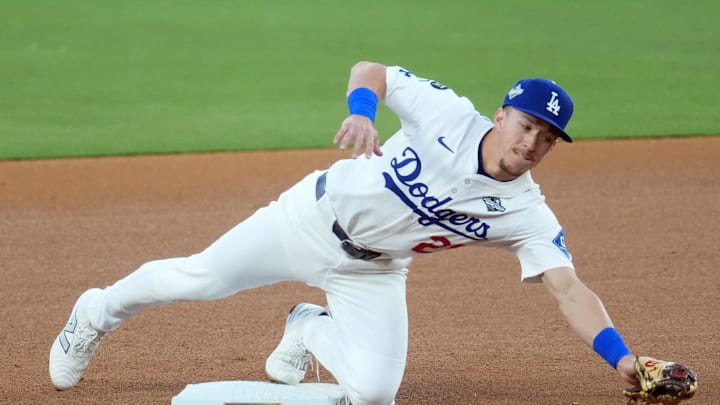 Oct 29, 2025; Los Angeles, California, USA; Los Angeles Dodgers second baseman Tommy Edman (25) makes a catch for an out against Toronto Blue Jays first baseman Vladimir Guerrero Jr. (27) in the third inning during game five of the 2025 MLB World Series at Dodger Stadium. Mandatory Credit: Kirby Lee-Imagn Images