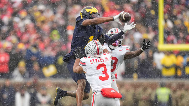 Michigan wide receiver Donaven McCulley (1) makes a catch against Ohio State cornerback Lorenzo Styles Jr. (3) and safety Jaylen McClain (18) during the second half at Michigan Stadium in Ann Arbor on Saturday, Nov. 29, 2025.