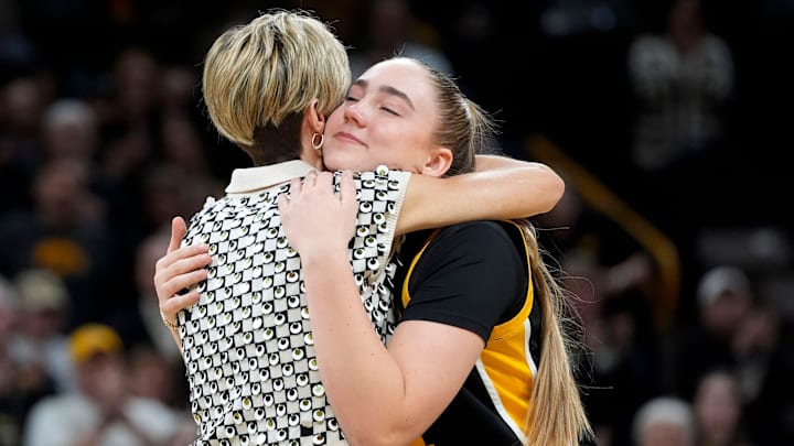 Iowa forward AJ Ediger (34) hugs Iowa head coach Jan Jensen during senior recognition after playing Wisconsin Sunday, March 2, 2025 at Carver-Hawkeye Arena in Iowa City, Iowa.