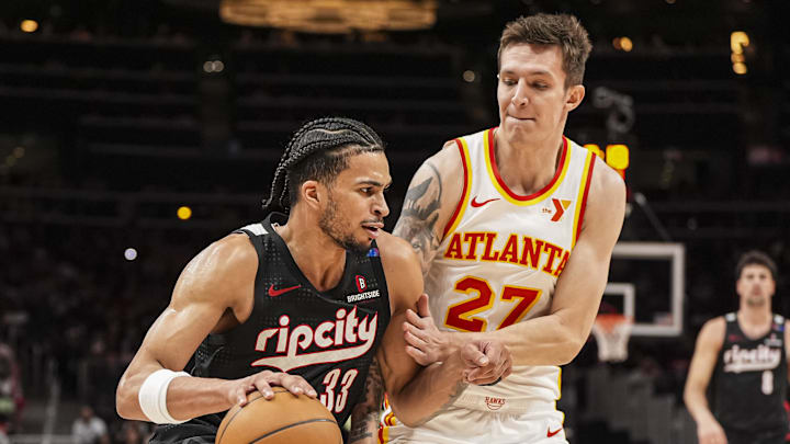 Apr 1, 2025; Atlanta, Georgia, USA; Portland Trail Blazers forward Toumani Camara (33) dribbles against Atlanta Hawks guard Vit Krejci (27) during the second half at State Farm Arena. Mandatory Credit: Dale Zanine-Imagn Images