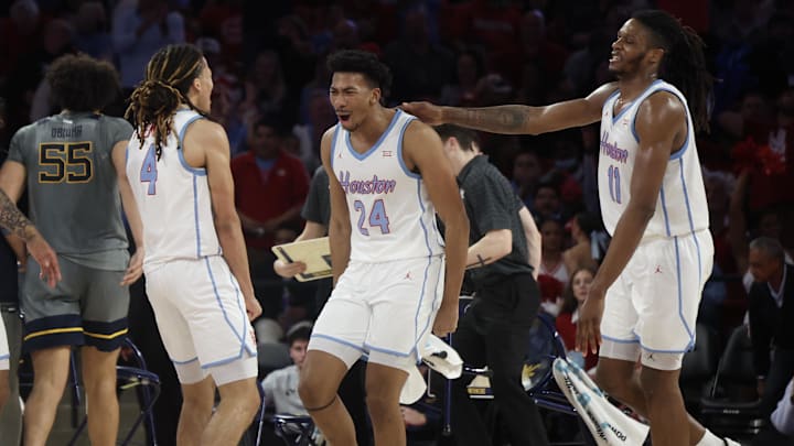 Jan 13, 2026; Houston, Texas, USA; Houston Cougars forward Chase McCarty (24) reacts to guard Kingston Flemings (4) basket against the West Virginia Mountaineers  in the second half at Fertitta Center. Mandatory Credit: Thomas Shea-Imagn Images