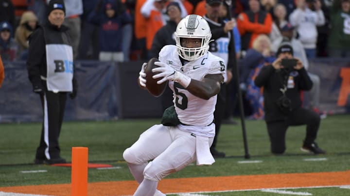Nov 16, 2024; Champaign, Illinois, USA; Michigan State Spartans running back Nate Carter (5) scores a touchdown during the second half against the Illinois Fighting Illini  at Memorial Stadium. Mandatory Credit: Ron Johnson-Imagn Images