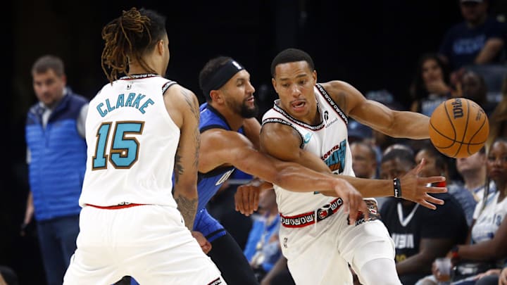 Oct 26, 2024; Memphis, Tennessee, USA; Memphis Grizzlies guard Desmond Bane (22) dribbles around a screen set by forward Brandon Clarke (15) on Orlando Magic guard Jalen Suggs (4) during the first half at FedExForum. Mandatory Credit: Petre Thomas-Imagn Images