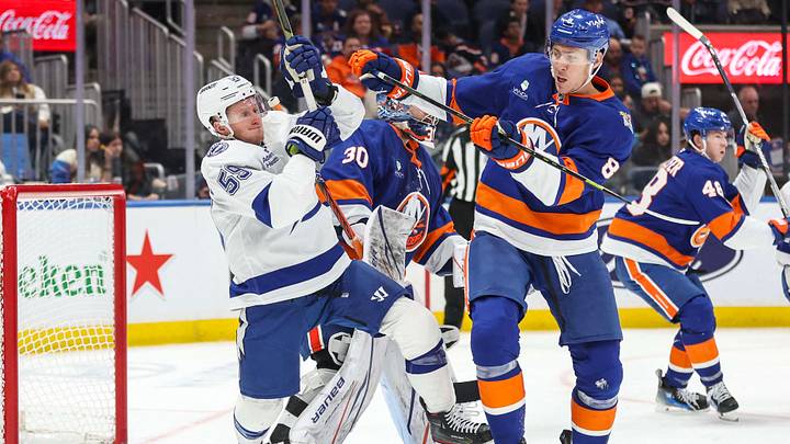 Oct 10, 2026; Elmont, New York, USA;  New York Islanders defenseman Logan Stanley (8) shoves Tampa Bay Lightning center Jake Guentzel (59) in the third period at UBS Arena.  Mandatory Credit: Wendell Cruz-Imagn Images