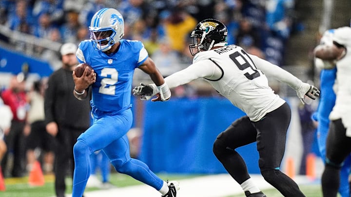 Detroit Lions quarterback Hendon Hooker (2) runs against Jacksonville Jaguars defensive end Arik Armstead (91) during the second half at Ford Field in Detroit on Sunday, Nov. 17, 2024.