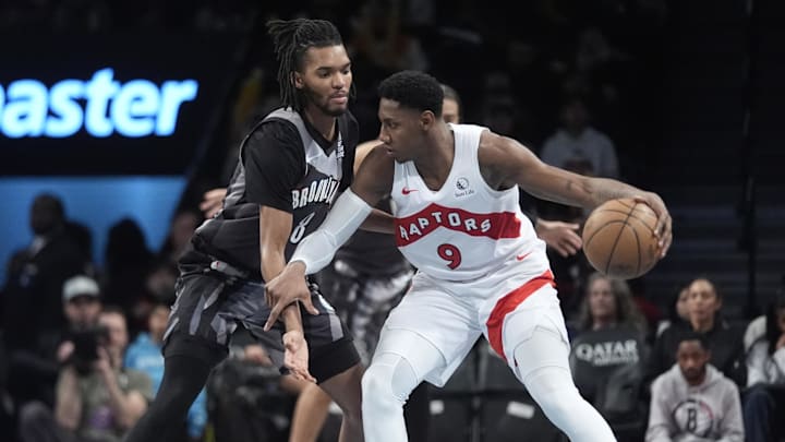 Toronto Raptors shooting guard RJ Barrett dribbles the ball against Brooklyn Nets forward Ziaire Williams.