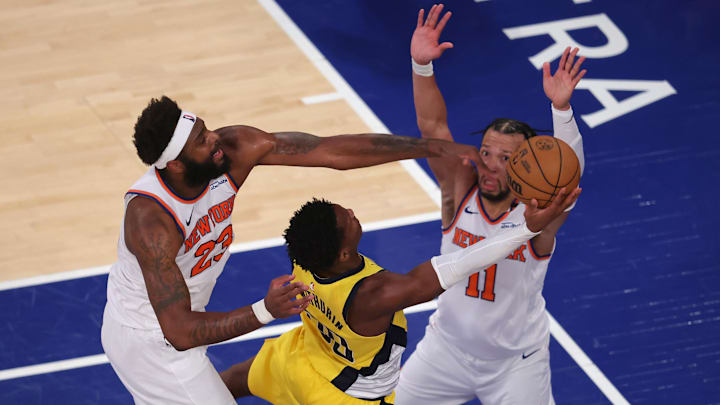 May 29, 2025; New York, New York, USA; Indiana Pacers guard Bennedict Mathurin (00) shoots against New York Knicks center Mitchell Robinson (23) and guard Jalen Brunson (11) in the third quarter during game five of the eastern conference finals for the 2025 NBA Playoffs at Madison Square Garden. Mandatory Credit: Brad Penner-Imagn Images
