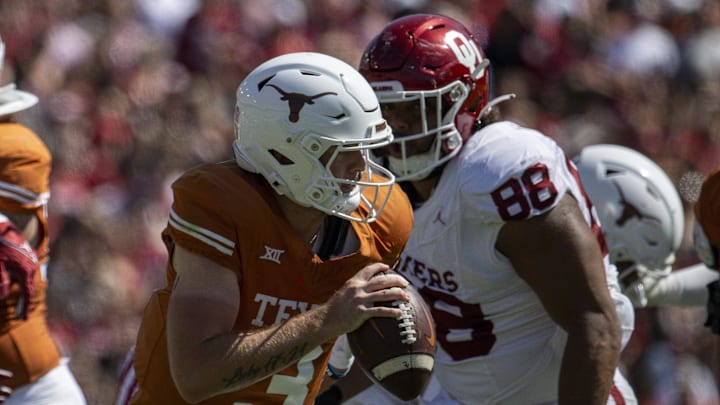 Oct 7, 2023; Dallas, Texas, USA; Texas Longhorns quarterback Quinn Ewers (3) attempts to elude the rush of Oklahoma Sooners defensive lineman Jordan Kelley (88) during the second half at the Cotton Bowl. Mandatory Credit: Jerome Miron-Imagn Images