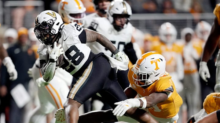 Vanderbilt running back Sedrick Alexander (28) runs past Tennessee linebacker Edwin Spillman (13) during the third quarter at Neyland Stadium in Knoxville, Tenn., Saturday, Nov. 29, 2025. Vanderbilt running back Sedrick Alexander (28) runs past Tennessee linebacker Edwin Spillman (13) during the third quarter at Neyland Stadium in Knoxville, Tenn., Saturday, Nov. 29, 2025.