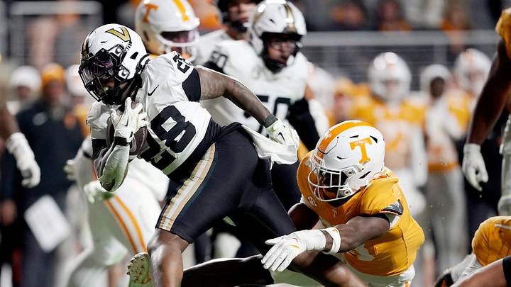 Vanderbilt running back Sedrick Alexander (28) runs past Tennessee linebacker Edwin Spillman (13) during the third quarter at Neyland Stadium in Knoxville, Tenn., Saturday, Nov. 29, 2025.
