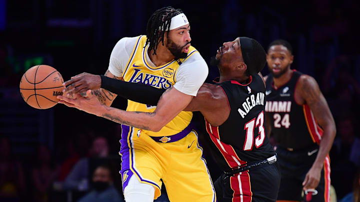 January 15, 2025; Los Angeles, California, USA; Miami Heat center Bam Adebayo (13) reaches for the ball against Los Angeles Lakers forward Anthony Davis (3) during the first half at Crypto.com Arena. Mandatory Credit: Gary A. Vasquez-Imagn Images