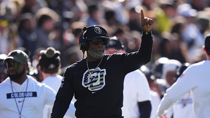 Nov 16, 2024; Boulder, Colorado, USA; Colorado Buffaloes head coach Deion Sanders calls in a play in the first quarter against the Utah Utes at Folsom Field. Mandatory Credit: Ron Chenoy-Imagn Images