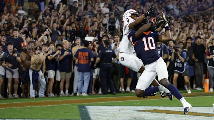 Sep 26, 2025; Charlottesville, Virginia, USA; Virginia Cavaliers defensive back Ja'son Prevard (10) makes a game winning interception in the end zone on a pass intended for Florida State Seminoles wide receiver Squirrel White (4) in the second overtime period at Scott Stadium. Mandatory Credit: Geoff Burke-Imagn Images Sep 26, 2025; Charlottesville, Virginia, USA; Virginia Cavaliers defensive back Ja'son Prevard (10) makes a game winning interception in the end zone on a pass intended for Florida State Seminoles wide receiver Squirrel White (4) in the second overtime period at Scott Stadium. Mandatory Credit: Geoff Burke-Imagn Images