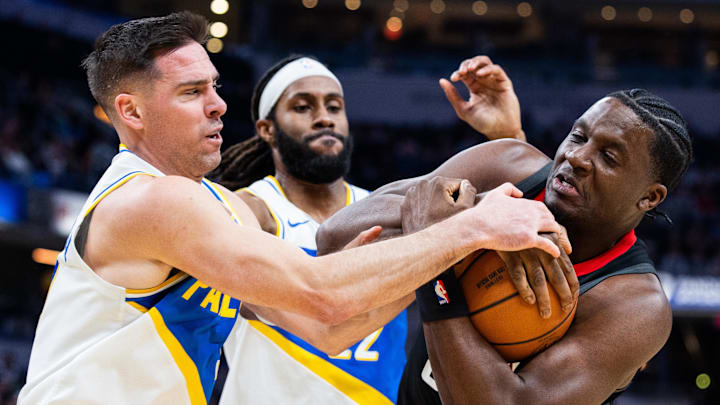 Feb 2, 2026; Indianapolis, Indiana, USA;  Indiana Pacers guard T.J. McConnell (9) and Houston Rockets center Clint Capela (30) fight for the ball  in the first half at Gainbridge Fieldhouse. Mandatory Credit: Trevor Ruszkowski-Imagn Images