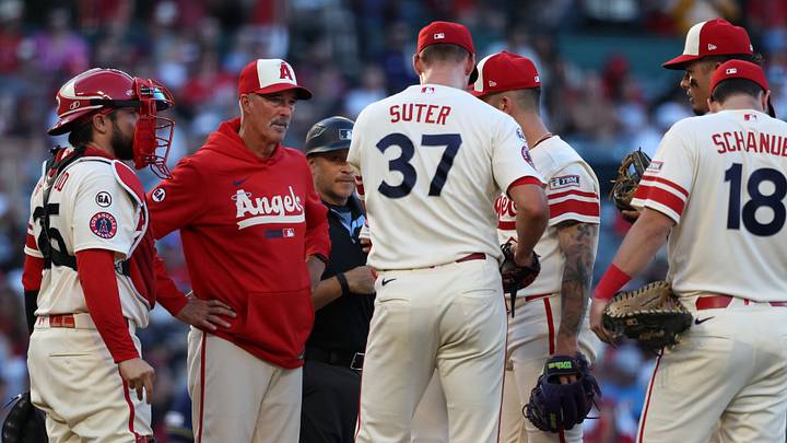Anaheim, California, USA;  Los Angeles Angels pitching coach Mike Maddux (second from left) talks with pitcher Brent Suter (37) during a mound visit in the second inning against the Milwaukee Brewers at Angel Stadium. Mandatory Credit: Kiyoshi Mio-Imagn Images