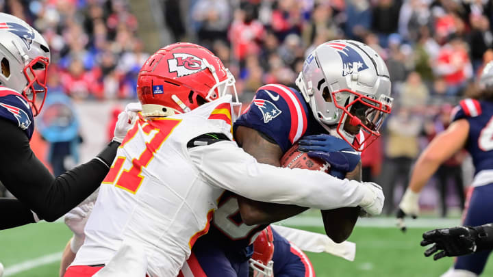 Dec 17, 2023; Foxborough, Massachusetts, USA; Kansas City Chiefs safety Chamarri Conner (27) tackles New England Patriots wide receiver Jalen Reagor (83) during the second half at Gillette Stadium. Mandatory Credit: Eric Canha-USA TODAY Sports