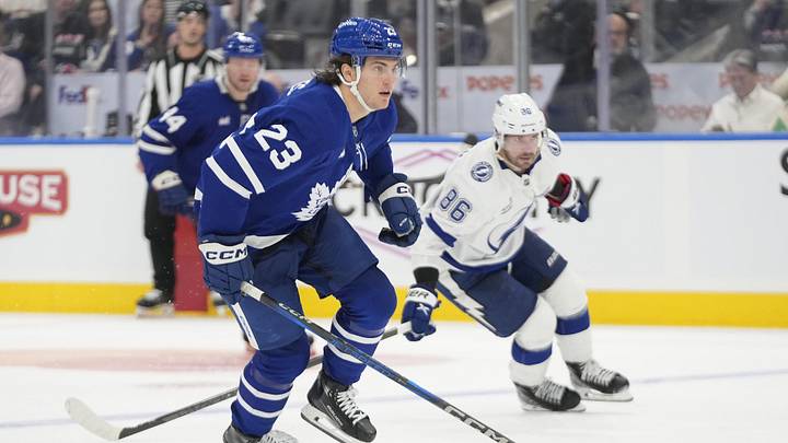 Oct 21, 2024; Toronto, Ontario, CAN; Toronto Maple Leafs forward Matthew Knies (23) carries the puck as Tampa Bay Lightning forward Nikita Kucherov (86) chases during the third period at Scotiabank Arena. Mandatory Credit: John E. Sokolowski-Imagn Images