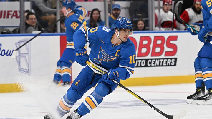 Jan 13, 2026; St. Louis, Missouri, USA; St. Louis Blues center Brayden Schenn (10) handles the puck against the Carolina Hurricanes in the second period at Enterprise Center. Mandatory Credit: Joe Puetz-Imagn Images