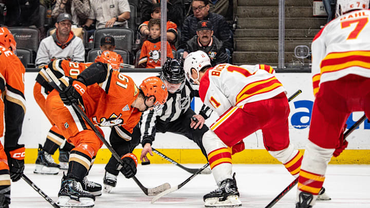 Mar 1, 2026; Anaheim, California, USA; Anaheim Ducks left wing Cutter Gauthier (61) faces off against Calgary Flames center Mikael Backlund (11) during overtime at Honda Center. Mandatory Credit: Corinne Votaw-Imagn Images