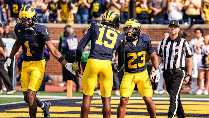 Michigan running back Jordan Marshall (23) celebrates a touchdown against Washington with quarterback Bryce Underwood (19) during the second half at Michigan Stadium in Ann Arbor on Saturday, Oct. 18, 2025.