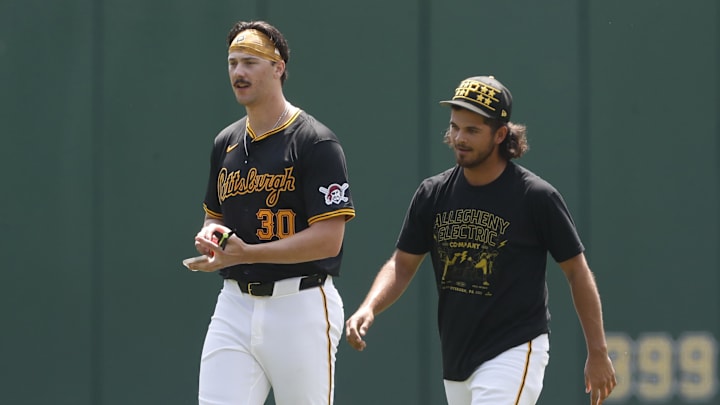 May 26, 2024; Pittsburgh, Pennsylvania, USA;  Pittsburgh Pirates pitchers Paul Skenes (left) and Jared Jones (right) walk in the outfield before the game against the Atlanta Braves at PNC Park. Mandatory Credit: Charles LeClaire-Imagn Images