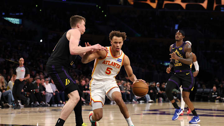 Jan 13, 2026; Los Angeles, California, USA;  Atlanta Hawks guard Dyson Daniels (5) drives to the basket against Los Angeles Lakers forward Dalton Knecht (4) during the first half at Crypto.com Arena. Mandatory Credit: Kiyoshi Mio-Imagn Images