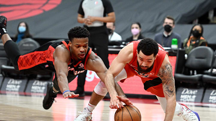 Jan 23, 2022; Toronto, Ontario, CAN;  Portland Trail Blazers guard Dennis Smith Jr. (10) and Toronto Raptors guard Fred VanVleet (23) battle for a loose ball in the second half at Scotiabank Arena. Mandatory Credit: Dan Hamilton-Imagn Images