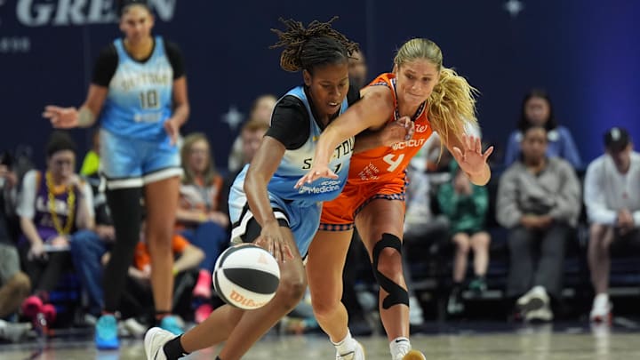 Jun 15, 2025; Uncasville, Connecticut, USA; Chicago Sky guard Ariel Atkins (7) drives the ball against Connecticut Sun guard Jacy Sheldon (4) in the second half at Mohegan Sun Arena. Mandatory Credit: David Butler II-Imagn Images
