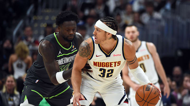 Apr 18, 2026; Denver, Colorado, USA; Denver Nuggets forward Aaron Gordon (32) handles the ball against Minnesota Timberwolves forward Julius Randle (30) during the first half in game one of the first round of the 2026 NBA Playoffs at Ball Arena.