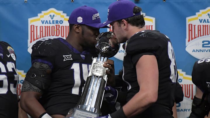 Dec 28, 2017; San Antonio, TX, United States; TCU Horned Frogs defensive end Ben Banogu (15) and tight end Cole Hunt (81) kiss the championship trophy after the 2017 Alamo Bowl against the Stanford Cardinal at Alamodome. TCU defeated Stanford 39-37. Mandatory Credit: Kirby Lee-Imagn Images