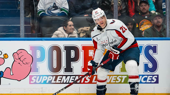Jan 21, 2026; Vancouver, British Columbia, CAN; Washington Capitals forward Nic Dowd (26) handles the puck against the Vancouver Canucks in the third period at Rogers Arena. Mandatory Credit: Bob Frid-Imagn Images