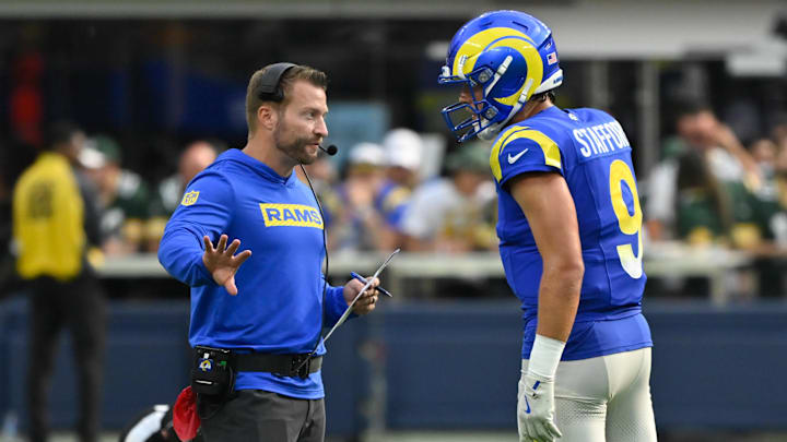 Oct 6, 2024; Inglewood, California, USA; Los Angeles Rams head coach Sean McVay talks to quarterback Matthew Stafford (9) during the third quarter against the Green Bay Packers at SoFi Stadium. Mandatory Credit: Robert Hanashiro-Imagn Images