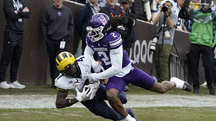 Nov 15, 2025; Chicago, Illinois, USA; Michigan Wolverines wide receiver Andrew Marsh (4) makes a catch as Northwestern Wildcats cornerback Fred Davis II (2) defends him during the first half at Wrigley Field. Mandatory Credit: David Banks-Imagn Images Nov 15, 2025; Chicago, Illinois, USA; Michigan Wolverines wide receiver Andrew Marsh (4) makes a catch as Northwestern Wildcats cornerback Fred Davis II (2) defends him during the first half at Wrigley Field. Mandatory Credit: David Banks-Imagn Images