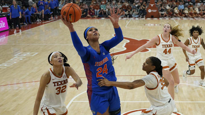 Mar 2, 2025; Austin, Texas, USA; Florida Gators center Ra Shaya Kyle (24) shoots over Texas Longhorns guard Ndjakalenga Mwenentanda (32) and forward Madison Booker (35) during the first half at Moody Center. Mandatory Credit: Scott Wachter-Imagn Images
