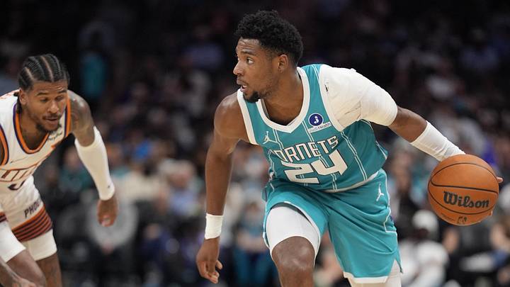 Charlotte Hornets forward Brandon Miller (24) moves the ball against Phoenix Suns guard Jalen Green Charlotte Hornets forward Brandon Miller (24) moves the ball against Phoenix Suns guard Jalen Green