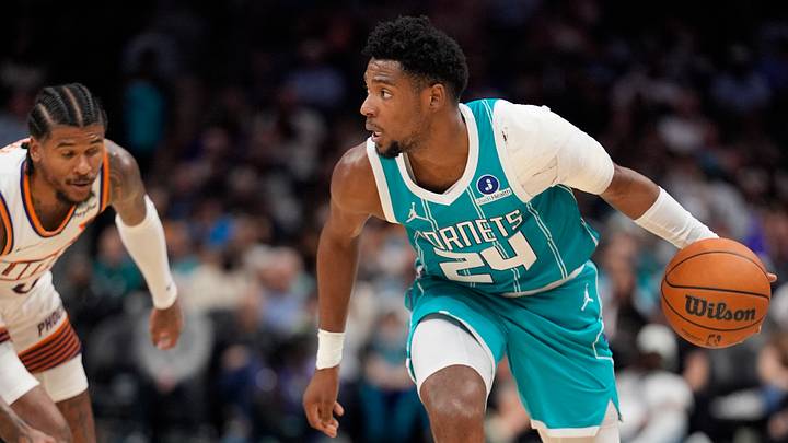 Charlotte Hornets forward Brandon Miller (24) moves the ball against Phoenix Suns guard Jalen Green Charlotte Hornets forward Brandon Miller (24) moves the ball against Phoenix Suns guard Jalen Green