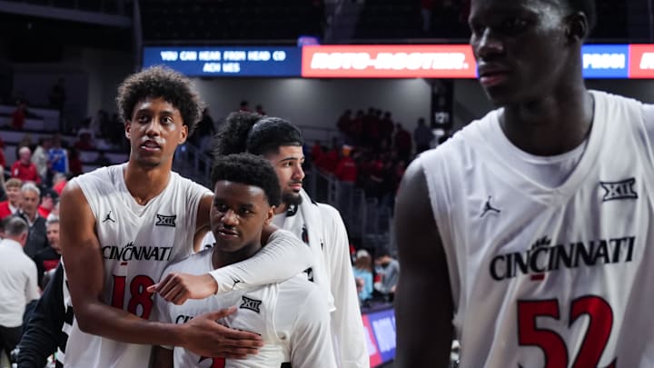 Mar 3, 2026; Cincinnati, Ohio, USA;  Cincinnati Bearcats forward Baba Miller, left, walks off the court with guard Jizzle James, right, after their team’s game against the BYU Cougars at Fifth Third Arena. Mandatory Credit: Aaron Doster-Imagn Images