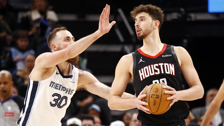 Jan 9, 2025; Memphis, Tennessee, USA; Houston Rockets center Alperen Sengun (28) handles the ball as Memphis Grizzlies center Jay Huff (30) defends during the second quarter at FedExForum. Mandatory Credit: Petre Thomas-Imagn Images