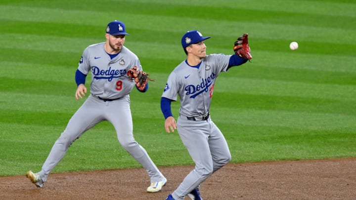 Oct 29, 2024; New York, New York, USA; Los Angeles Dodgers outfielder Tommy Edman (25) fields a ground ball in front of second baseman Gavin Lux (9) during the first inning in game four of the 2024 MLB World Series against the New York Yankees at Yankee Stadium. Mandatory Credit: John Jones-Imagn Images