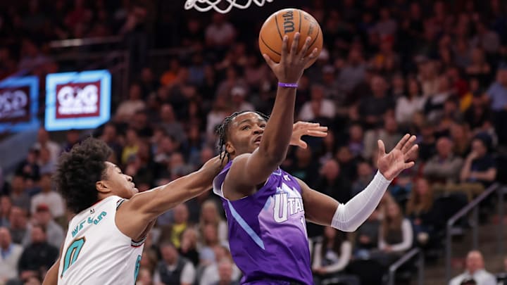 Mar 25, 2025; Salt Lake City, Utah, USA;  Utah Jazz guard Isaiah Collier (13) gets past Memphis Grizzlies forward Jaylen Wells (0) and to the basket during the first quarter at Delta Center. Mandatory Credit: Chris Nicoll-Imagn Images