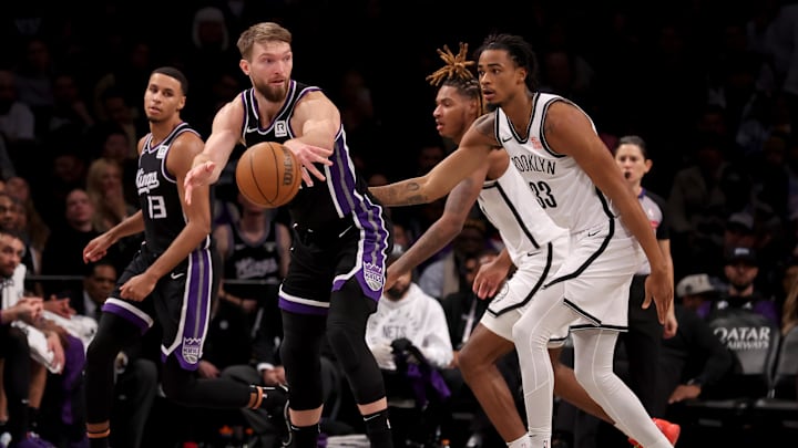 Sacramento Kings forward Domantas Sabonis passes the ball against Brooklyn Nets center Nic Claxton. Sacramento Kings forward Domantas Sabonis passes the ball against Brooklyn Nets center Nic Claxton.