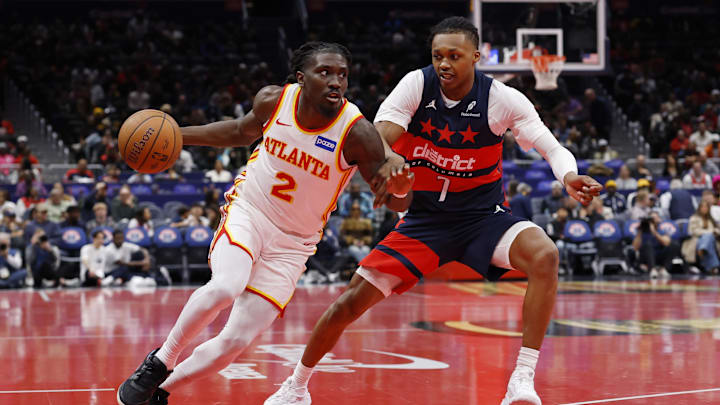 Nov 25, 2025; Washington, District of Columbia, USA; Atlanta Hawks guard Keaton Wallace (2) drives to the basket as Washington Wizards guard Bub Carrington (7) defends in the first half at Capital One Arena. Mandatory Credit: Geoff Burke-Imagn Images