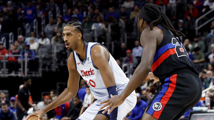 Mar 13, 2025; Detroit, Michigan, USA;  Washington Wizards forward Alex Sarr (20) dribbles defended by Detroit Pistons center Isaiah Stewart (28) in the first half at Little Caesars Arena. Mandatory Credit: Rick Osentoski-Imagn Images