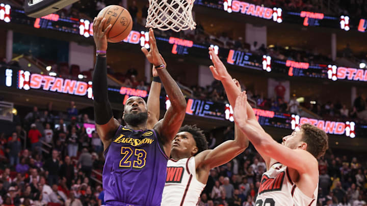 Jan 5, 2025; Houston, Texas, USA; Los Angeles Lakers forward LeBron James (23) makes a basket against Houston Rockets center Alperen Sengun (28)  in the fourth quarter at Toyota Center. Mandatory Credit: Thomas Shea-Imagn Images