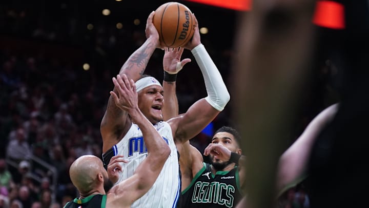 Apr 29, 2025; Boston, Massachusetts, USA; Boston Celtics guard Derrick White (9) and forward Jayson Tatum (0) defend against Orlando Magic forward Paolo Banchero (5) in the second quarter during game five of first round for the 2025 NBA Playoffs at TD Garden. Mandatory Credit: David Butler II-Imagn Images