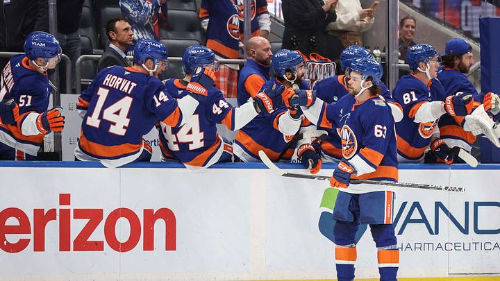 Oct 13, 2026; Elmont, New York, USA;  New York Islanders left wing Matias MacCelli (63) celebrates with his teammates after scoring a goal in the first period against the Vancouver Canucks at UBS Arena. Mandatory Credit: Wendell Cruz-Imagn Images