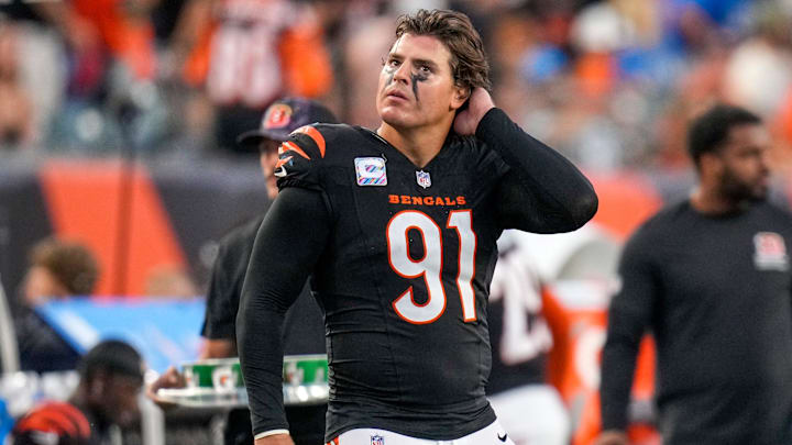 Cincinnati Bengals defensive end Trey Hendrickson (91) watches a replay as the Detroit Lions celebrate a touchdown in the fourth quarter of the NFL Week 5 game between the Cincinnati Bengals and the Detroit Lions at Paycor Stadium in downtown Cincinnati on Sunday, Oct. 5, 2025. The Bengals continued a losing streak, falling 37-24 to the Lions.